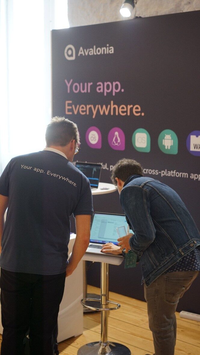 A demo on a laptop at the Avalonia booth, beneath a "Your app. Everywhere." banner