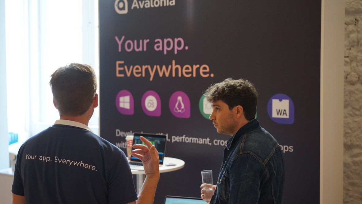 Two people talking at the Avalonia conference booth