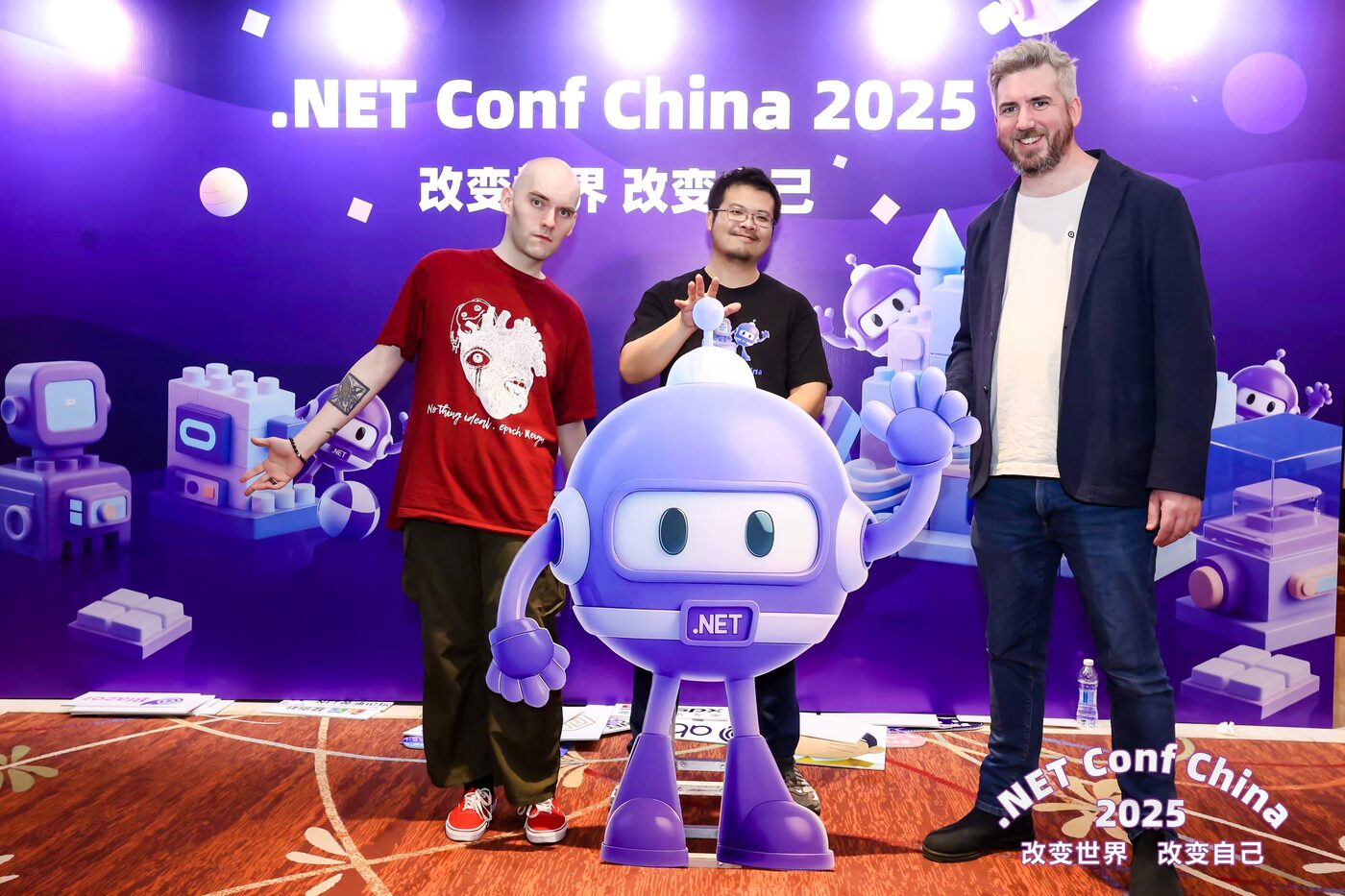 Three Avalonia team members on stage with the .NET mascot at .NET Conf China 2025